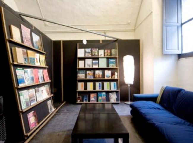 Tue Greenfort, Microenvironment, 2008, library, couch, lamp, heater and various books, dimensions variable (courtesy of the artist, Fondazione Morra Greco, Napoli, and Johann König, Berlin)